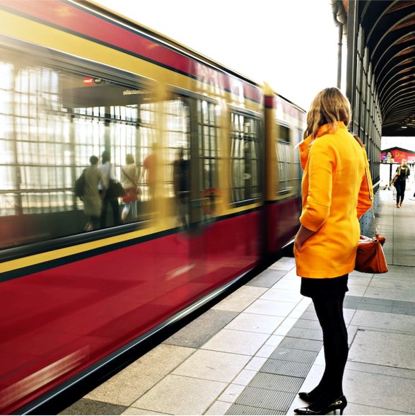 photo of a woman standing by a train